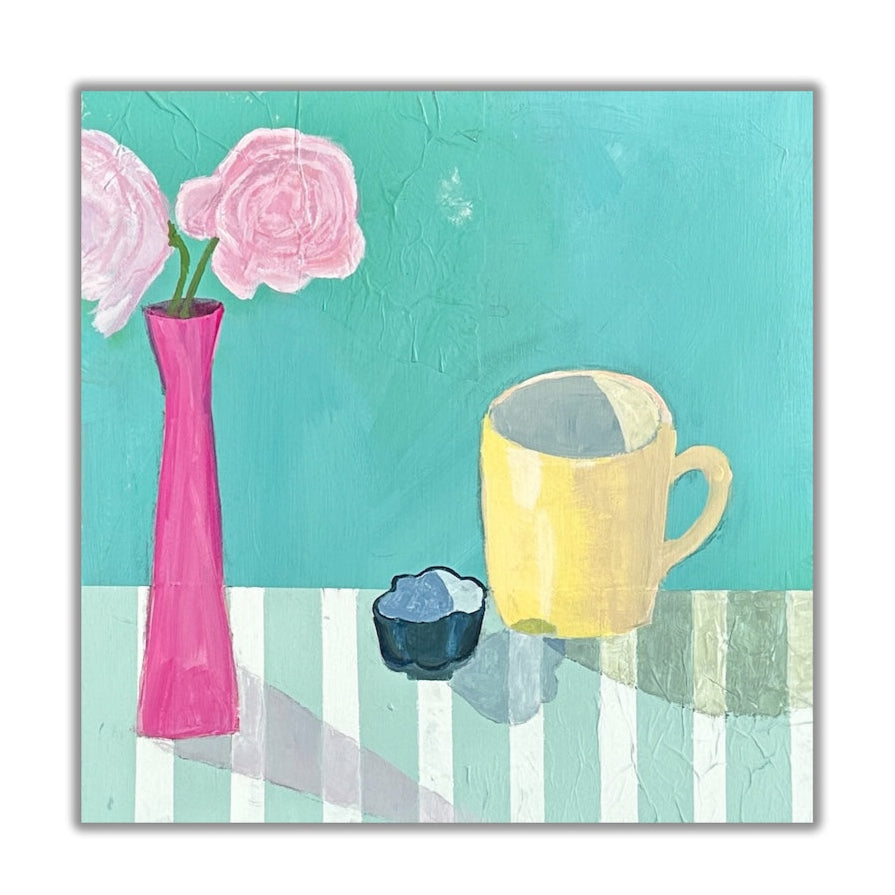 brightly colored still life. yellow mug and fuchsia vase sitting on striped table.