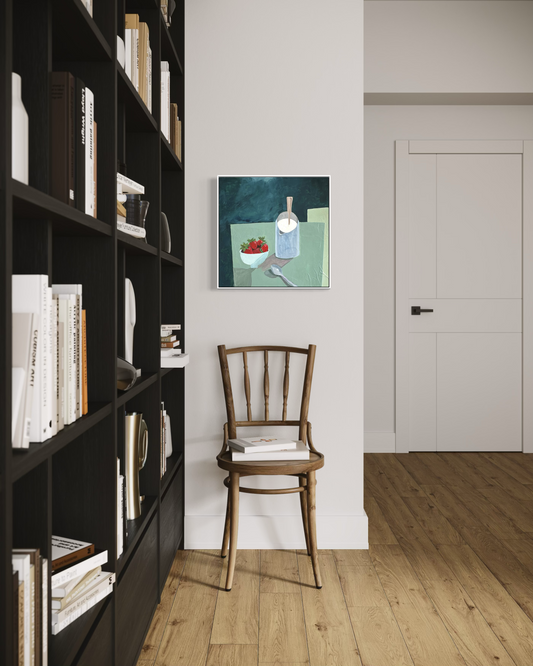 Room interior with a bookshelf, wooden chair, and an original still life painting of a bowl of strawberries and a pitcher of cream.