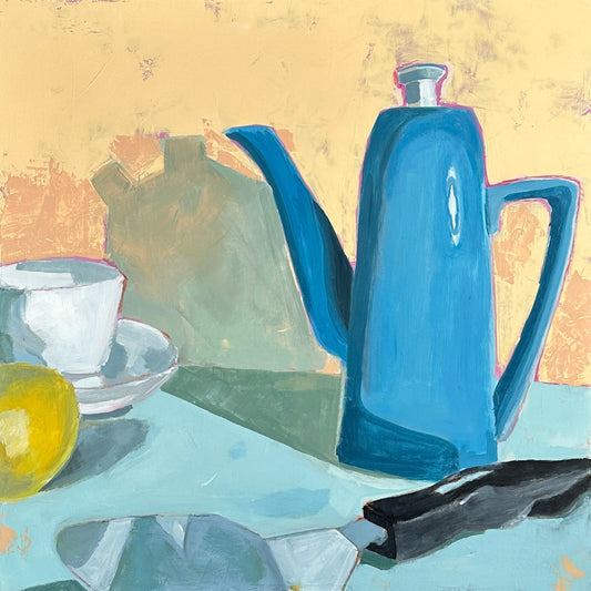 still life in bold colors of blues and peach, blue teapot, white teacup, yellow lemon and a pie knife. 