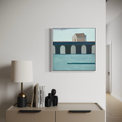 Framed artwork of a coastal scene on a wall above a cabinet with decor items.