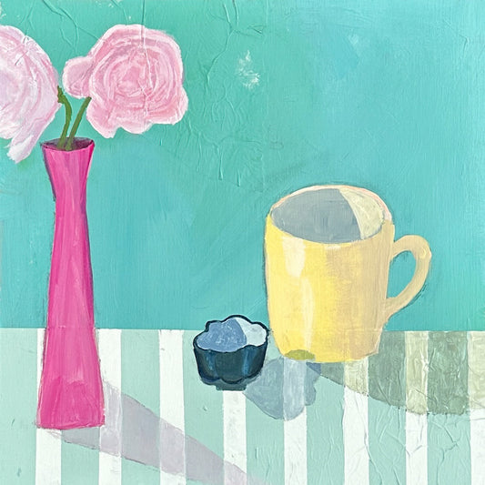 brightly colored still life. yellow mug and fuchsia vase  sitting on striped table.