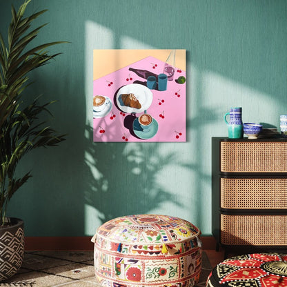 Still life painting of coffee and croissant on a table with cherry tablecloth hung in room with turquoise wall. 