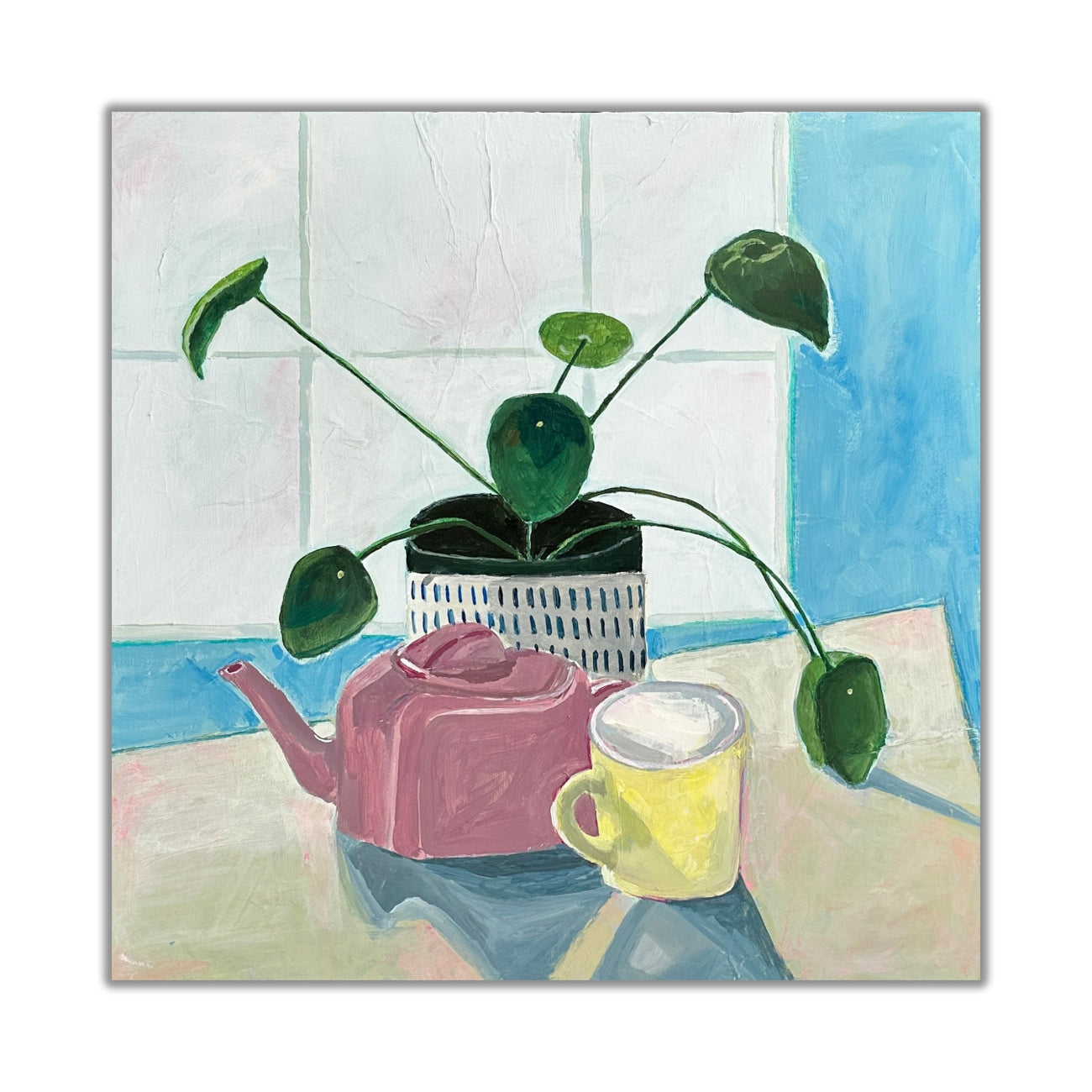 still life of a money plant, pink teapot, and yellow mug on a table in front of a window.