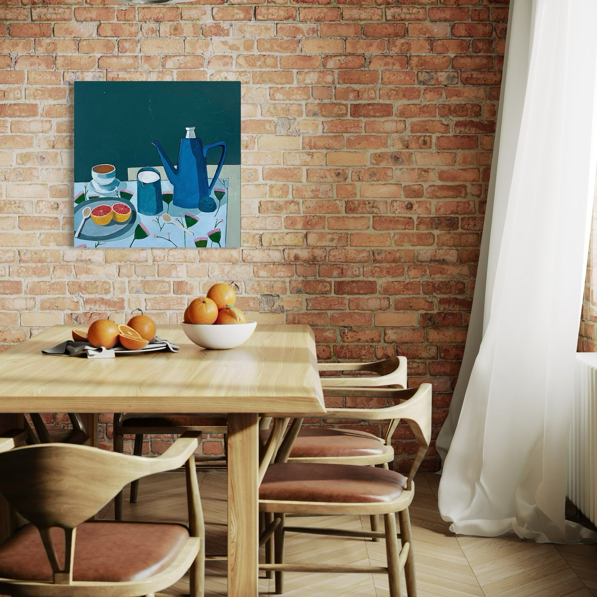 Dining area with a wooden table and chairs against a brick wall, featuring a still life painting above the table.