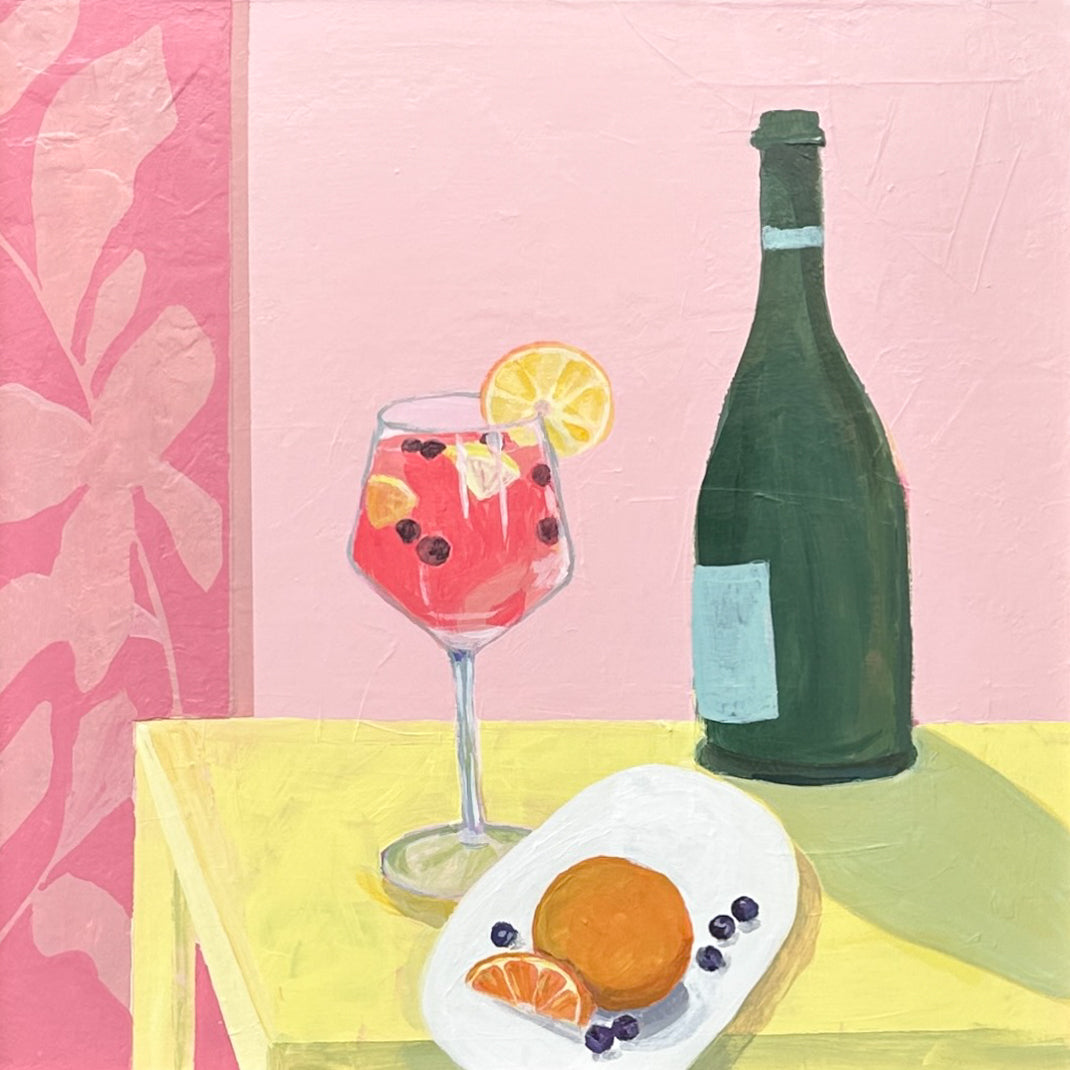 A still life painting featuring a pink cocktail in a wine glass with a lemon slice, a dark green bottle, and an orange on a white plate, set on a yellow table against a pink background.