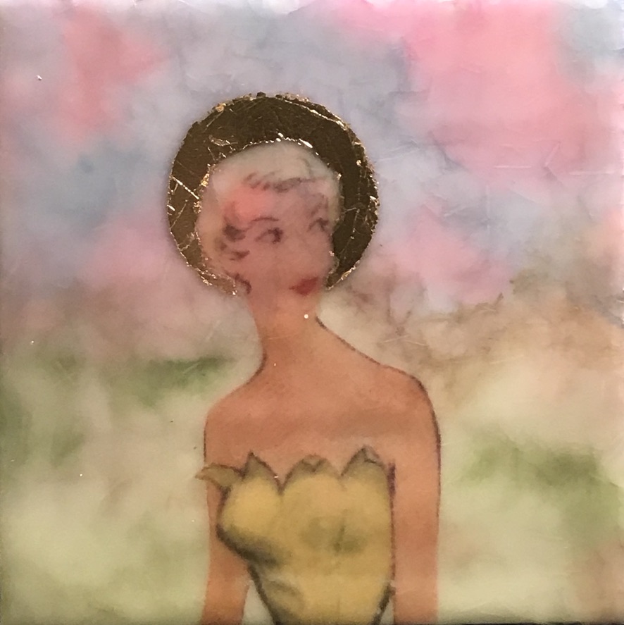 square encaustic painting of image transfer of woman from vintage dress pattern, in front of sunset sky. woman has a gold leaf halo.