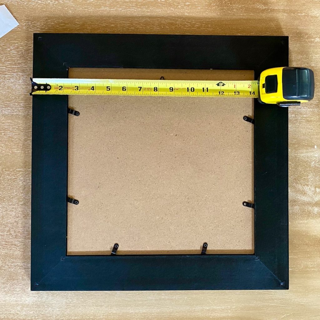 image of the back of a picture frame with ruler on top
